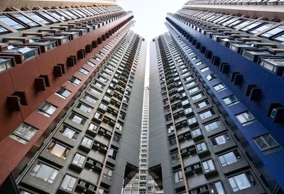 Low angle view of modern buildings in city against sky