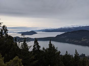 Scenic view of lake against sky during winter