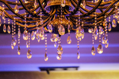 Low angle view of chandelier hanging from ceiling