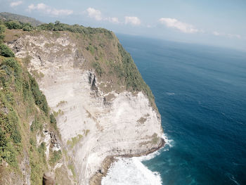 High angle view of shore by sea against sky