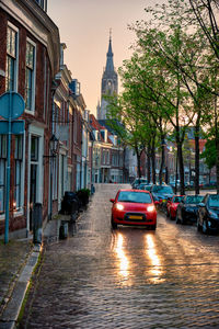 Cars on street amidst buildings in city