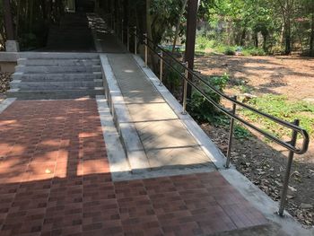 High angle view of footpath by railing in park