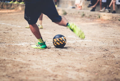 Low section of man playing with ball