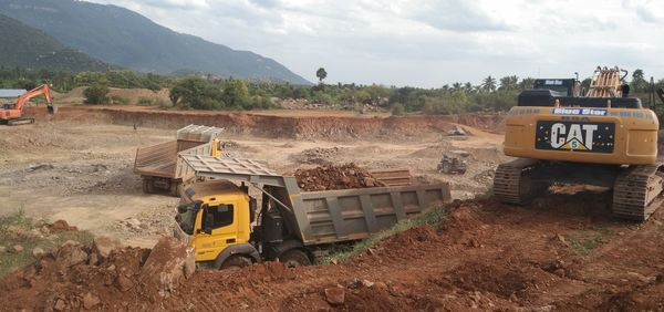 Construction site by road against sky