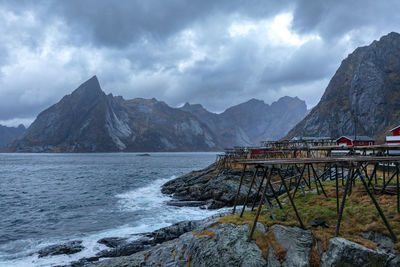 Scenic view of sea and mountains against sky