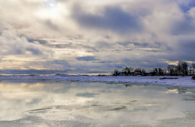 Scenic view of lake against sky during winter