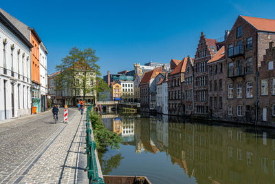 Canal amidst buildings in town against sky