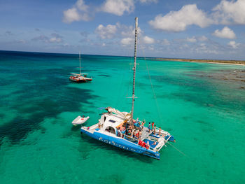 Boats sailing in sea against sky