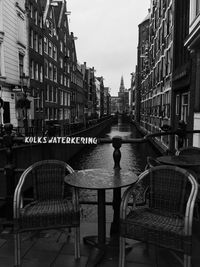 Man on table in city against sky