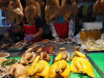 High angle view of people for sale at market stall