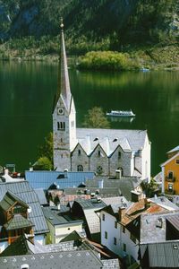 Traditional building by lake and trees