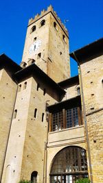 Low angle view of bell tower against sky