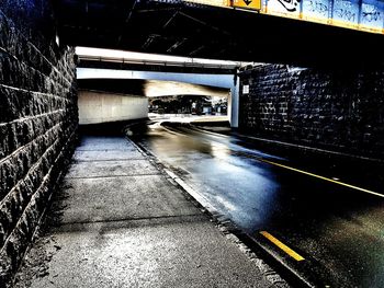 Road in illuminated tunnel