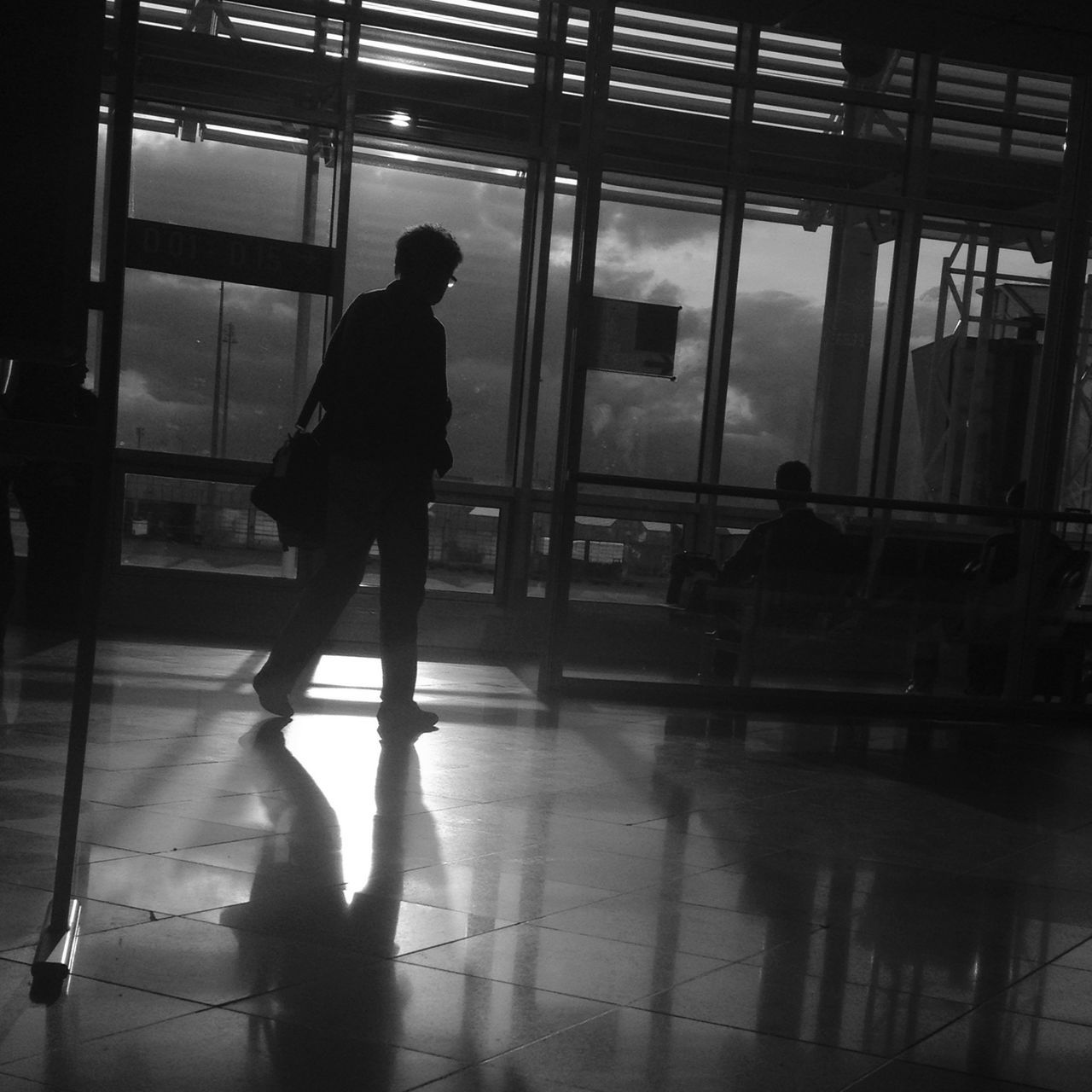 indoors, men, glass - material, silhouette, full length, walking, rear view, lifestyles, window, reflection, transparent, person, built structure, architecture, standing, leisure activity, transportation, passenger