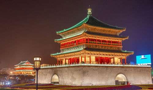 Low angle view of illuminated building against sky