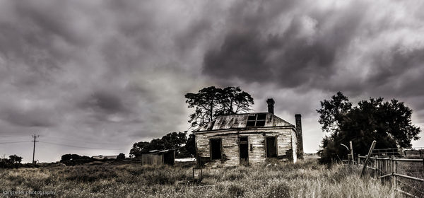 Low angle view of abandoned factory against sky