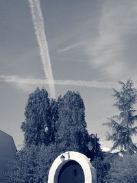 Low angle view of trees and building against sky