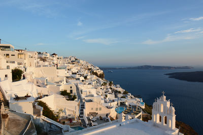 High angle view of townscape by sea against sky