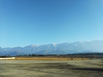 Scenic view of landscape against clear blue sky