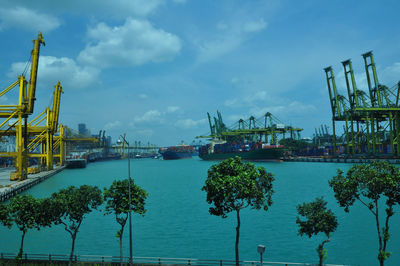 Commercial dock by sea against sky