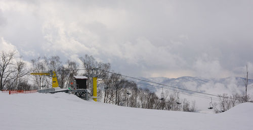 Snow covered land and mountains against sky