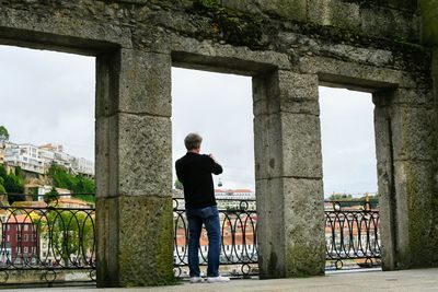 Rear view of man standing against sky