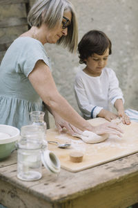 Rear view of mother and daughter on table