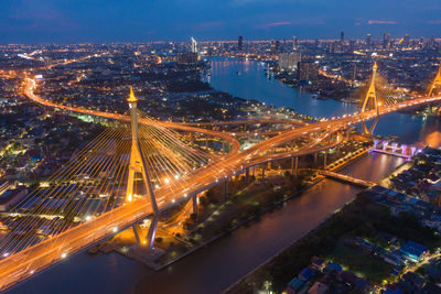 High angle view of illuminated street amidst buildings at night