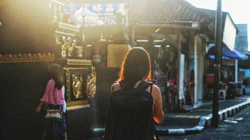 Women walking on footpath in city