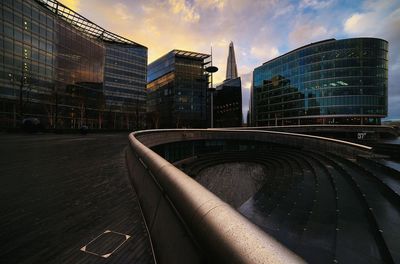 Buildings in city against cloudy sky