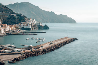 Scenic view of sea by buildings against sky