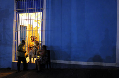 People in illuminated room