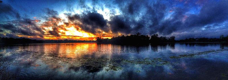 Scenic view of lake against cloudy sky