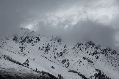 Low angle view of snow covered mountain against sky