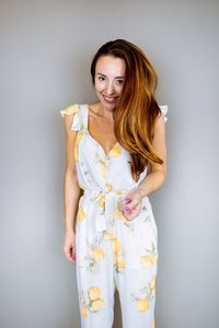 Portrait of smiling young woman against white background