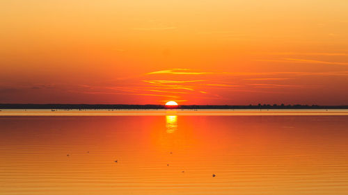 Scenic view of sea against romantic sky at sunset