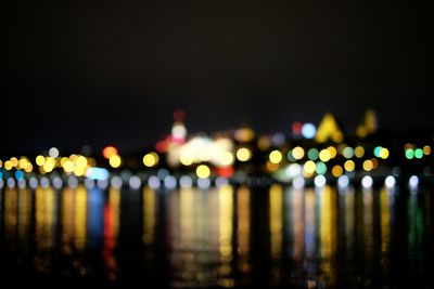 Reflection of illuminated lights in puddle at night