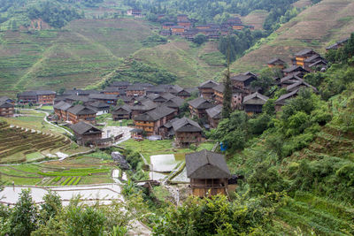 High angle view of houses and trees in village