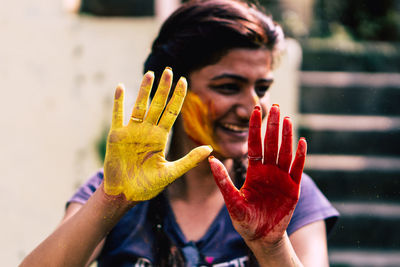 Close-up of smiling woman covered with powder paint