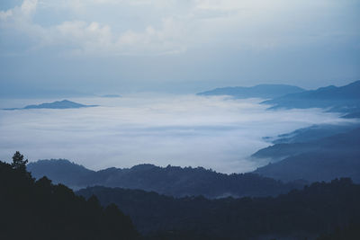 Scenic view of silhouette mountains against sky