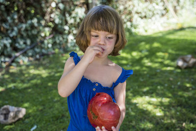 Portrait of a girl holding apple