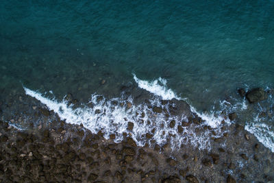 High angle view of waves splashing on shore