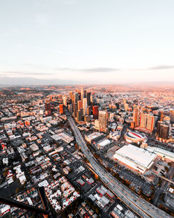 Aerial view of cityscape against sky during sunset