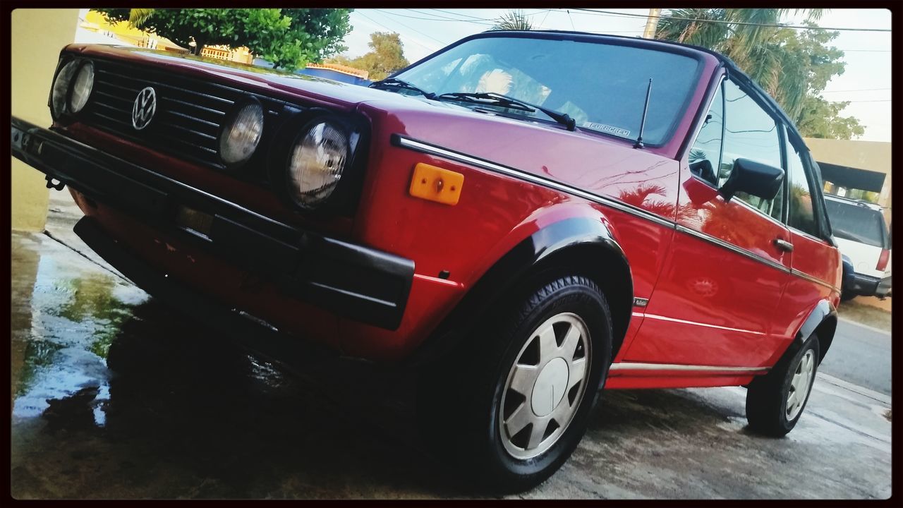 transportation, mode of transport, land vehicle, car, transfer print, stationary, auto post production filter, street, old-fashioned, parking, red, travel, day, tree, vintage car, outdoors, parked, retro styled, no people, reflection