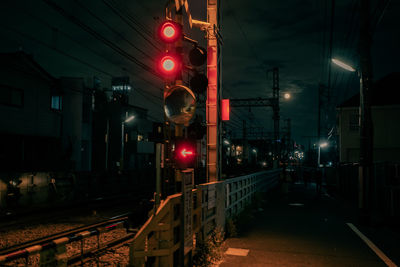 Train on illuminated railroad station platform at night