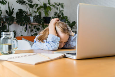 Woman using laptop at table