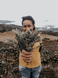 Full length of young woman standing on field