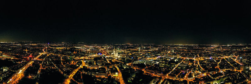 High angle view of illuminated city against sky at night