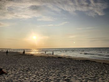 Scenic view of beach against sky during sunset