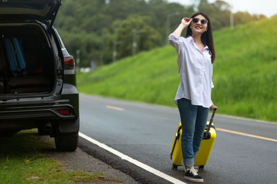 Full length of woman standing on road